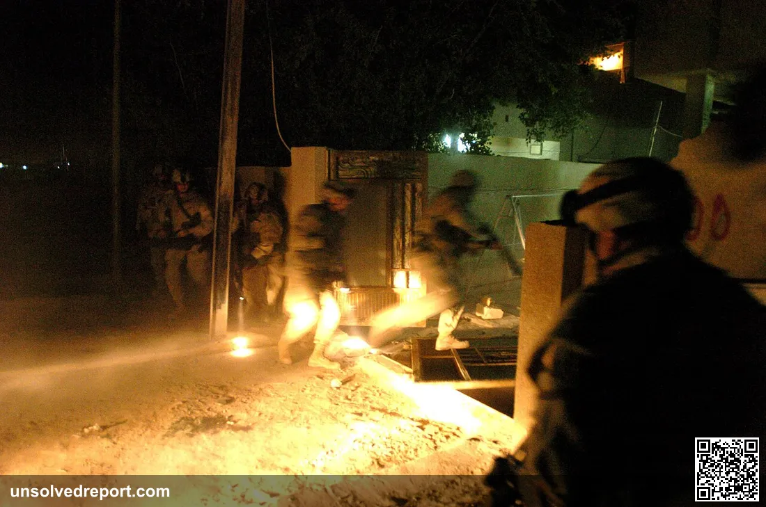 Soldiers from Battery A, 1st Battalion, 9th Field Artillery, 2nd Brigade Combat Team, 3rd Infantry Division raid a hous…