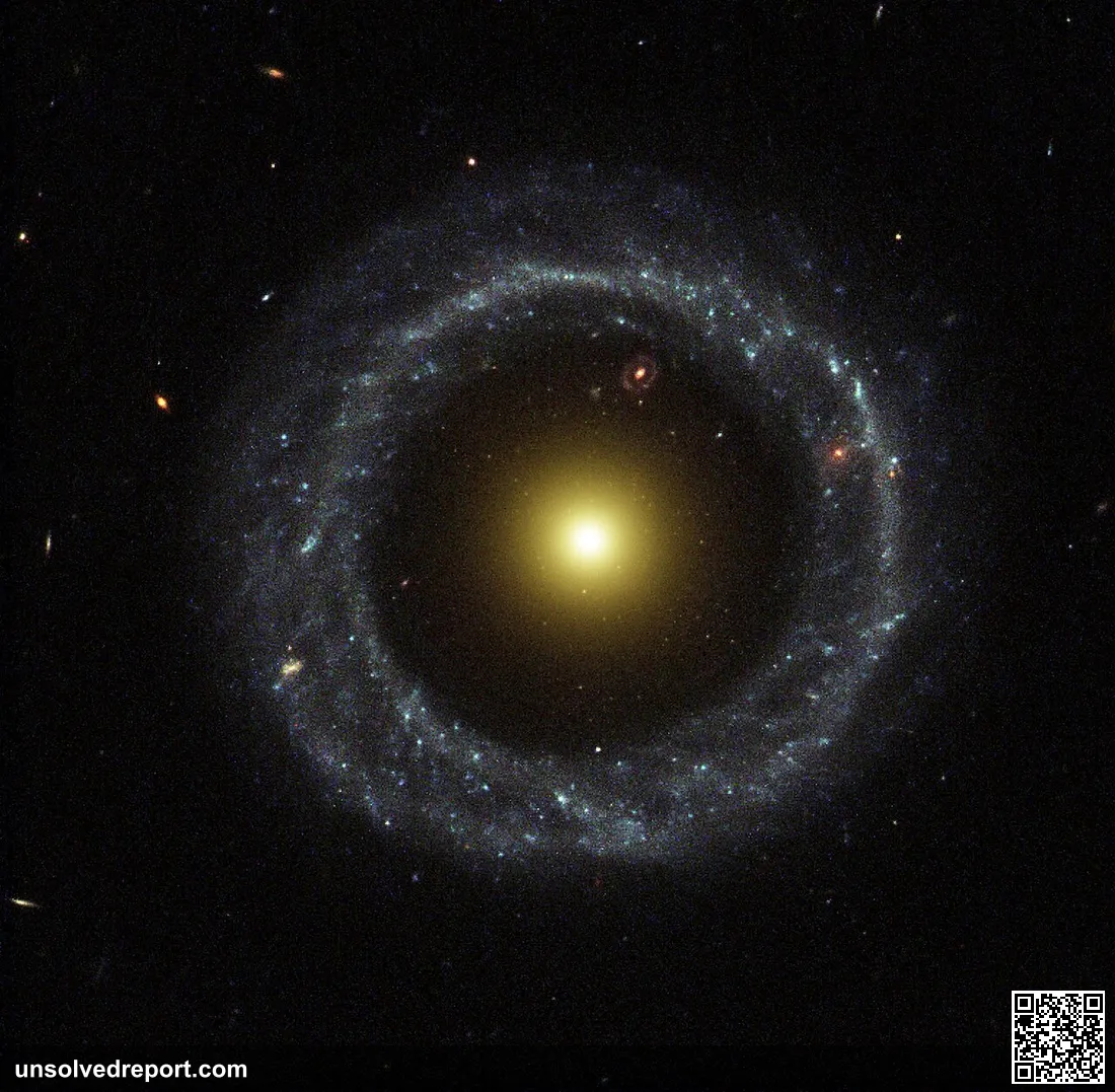 A nearly perfect ring of hot, blue stars pinwheels about the yellow nucleus of an unusual ring galaxy known as Hoag's O…