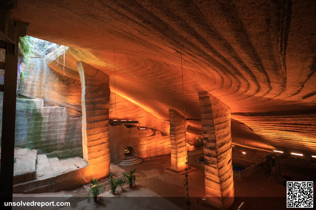 Interior of Longyou Cave No. 2 (Xiaonanhai Stone Chamber), showing the enormous hand-carved cavern with stone pillars supporting the ceiling, Zhejiang, China