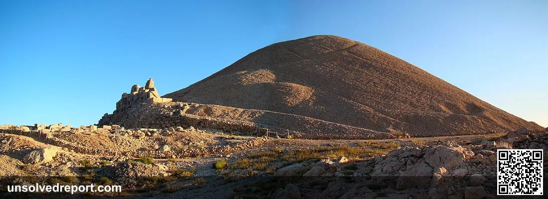 The artificial, man-made peak of Mount Nemrut (Turkish: "Nemrut Dağı"). The photo was taken shortly before sunset. On t…