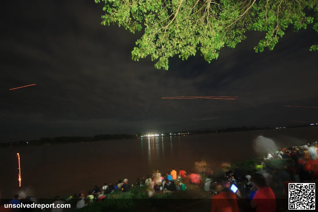 Glowing orbs of the Naga Fireballs phenomenon rising silently over the Mekong River, photographed at Phon Phisai, Nong Khai Province, Thailand