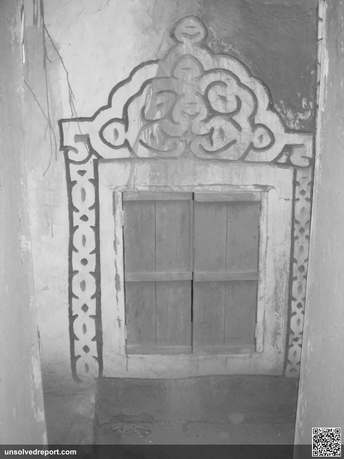 A decorative window in Oualata, Mauritania, featuring traditional geometric patterns painted in ochre and white
