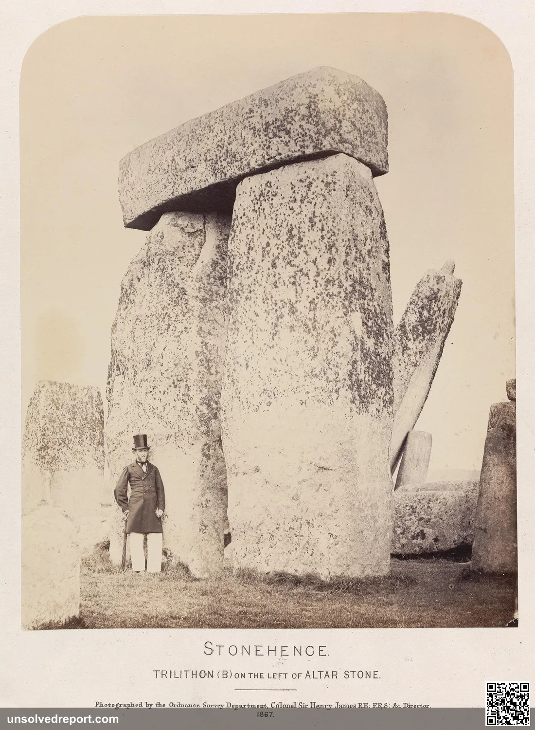 Stonehenge, Trilithon on the left of the Altar Stone — an 1867 photograph showing the massive sarsen trilithon beside the Altar Stone, with a person for scale